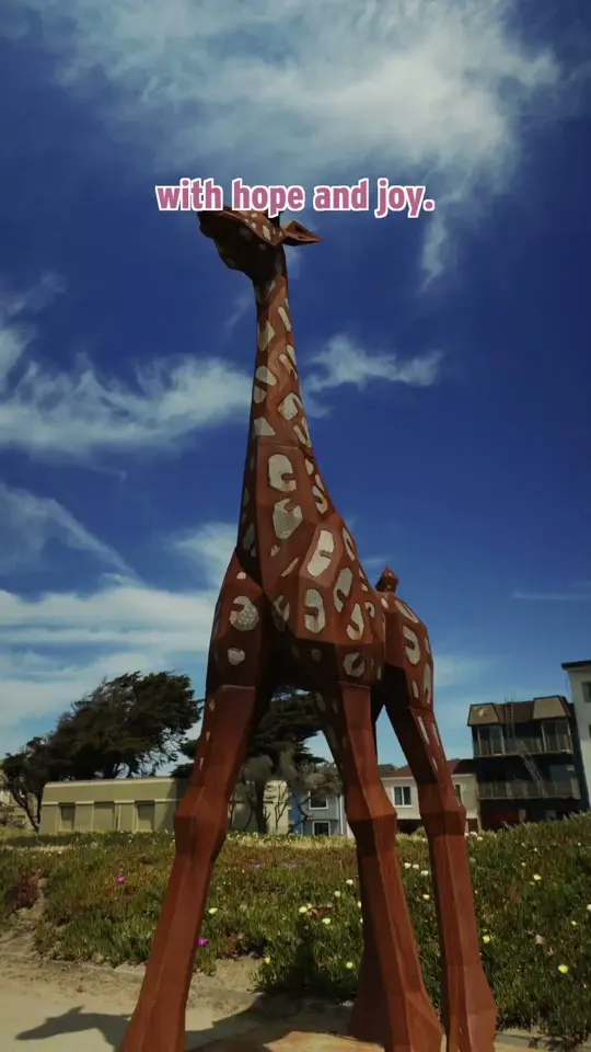 A giant sculpture under a blue sky at a park opening